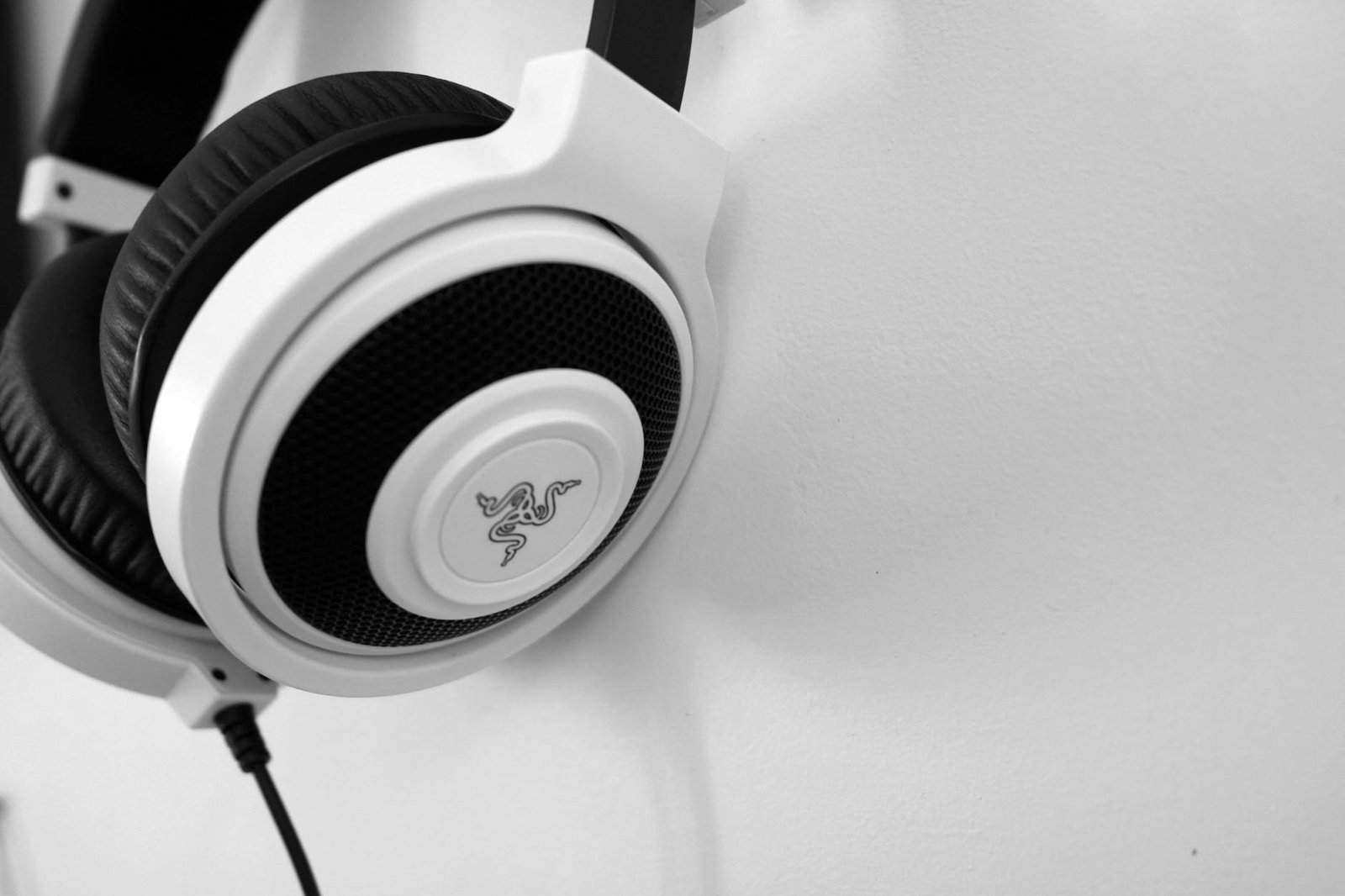 Close-up view of sleek white headphones against a minimalist background, perfect for technology enthusiasts.