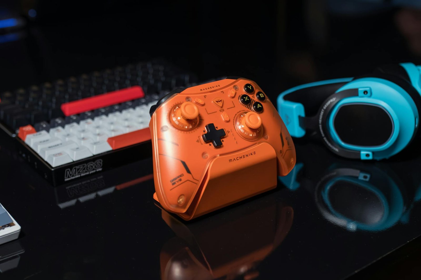 Dynamic gaming setup featuring an orange controller, keyboard, and blue headset.