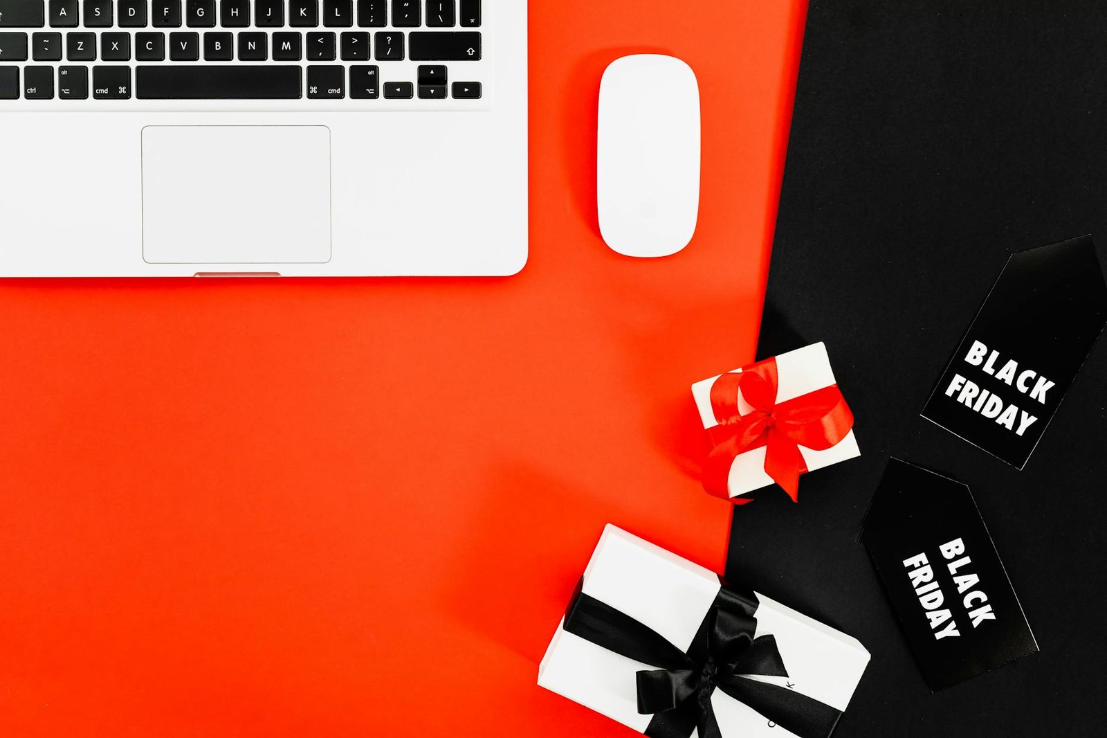 Modern flat lay of laptop and gift boxes for Black Friday shopping.