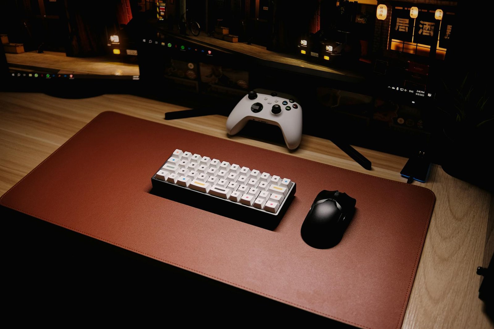 High-angle view of a sleek gaming setup featuring a mechanical keyboard and controller.