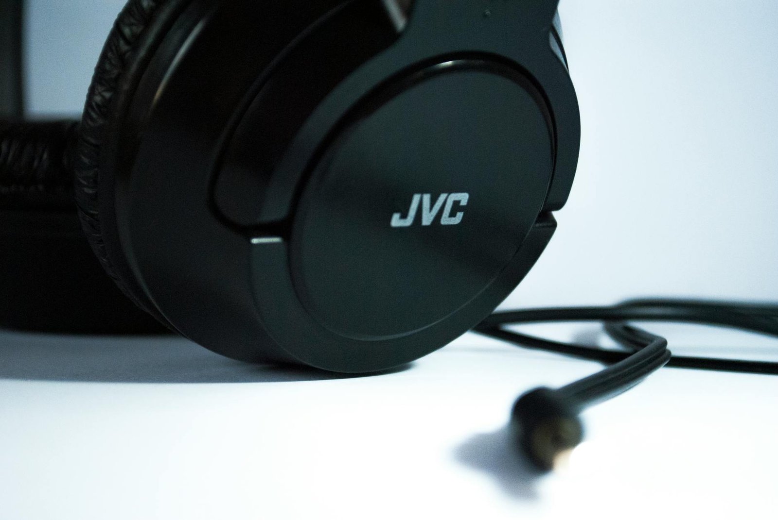 Detailed close-up of black JVC headphones with a visible cord, highlighting modern audio technology.