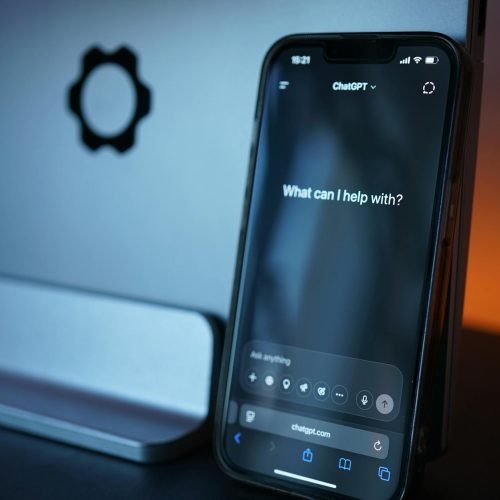 Close-up of a smartphone with AI chat interface, showcasing advanced technology in a sleek design.