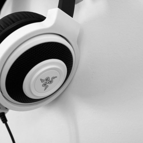 Close-up view of sleek white headphones against a minimalist background, perfect for technology enthusiasts.