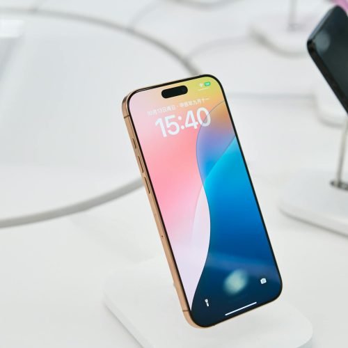 Close-up of a stylish smartphone in a tech showroom, highlighting its sleek design.