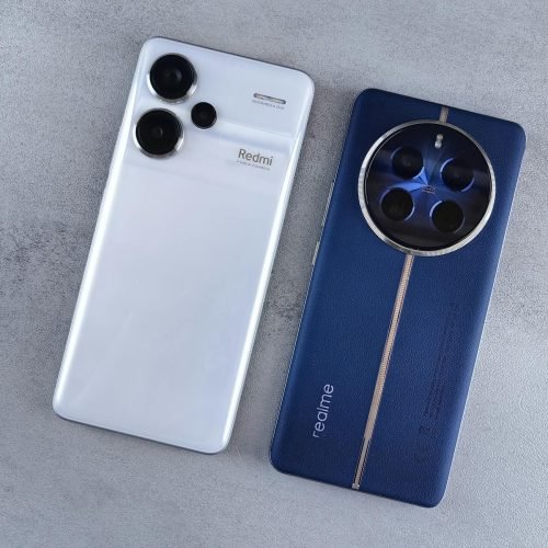 Two smartphones, one white and one blue, displayed on a textured grey background.