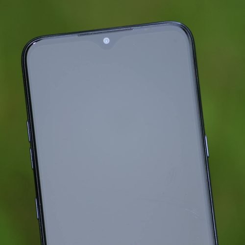 Close-up view of a smartphone screen with a green background, ideal for tech themes.