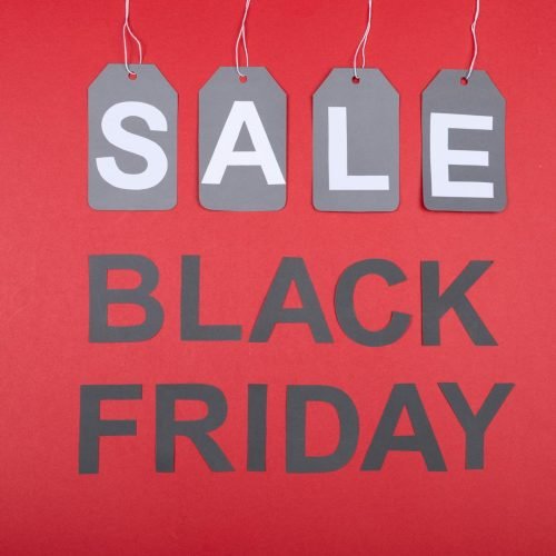 Red background with SALE tags and Black Friday text, ideal for promotions.