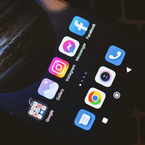 Smartphone screen showing popular social media and app icons including Facebook and Instagram.