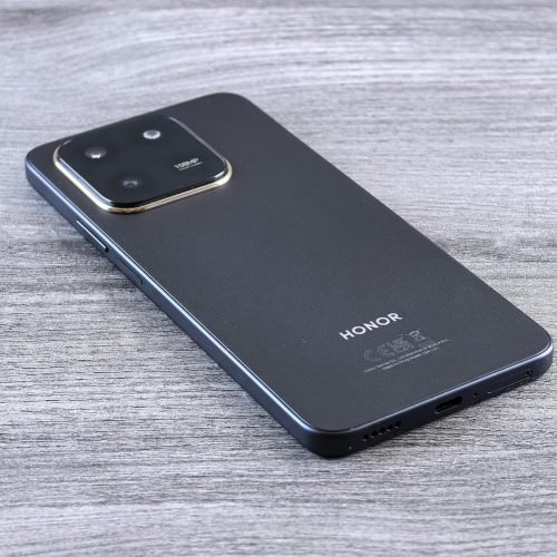 Close-up of a modern smartphone with a sleek design on a wooden surface.