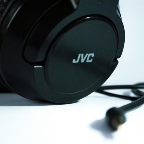 Detailed close-up of black JVC headphones with a visible cord, highlighting modern audio technology.