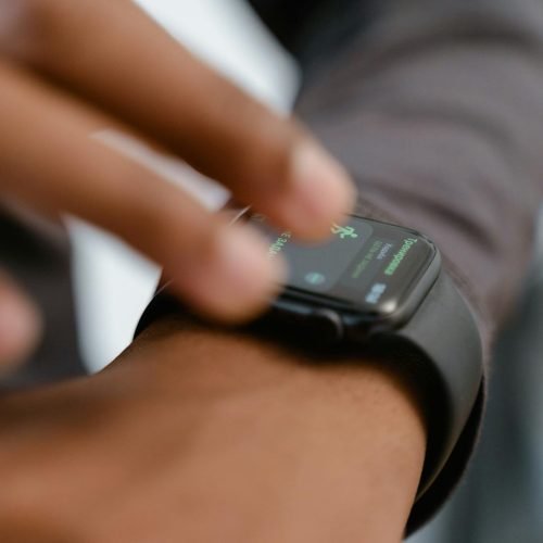 A detailed image showing a person interacting with a smartwatch, highlighting fitness tracking capabilities.